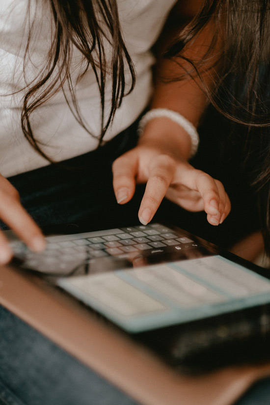 hands interacting with a tablet keyboard in a casual setting focusing on digital communication two users engaged