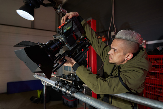 man adjusting professional camera setup in film studio environment focusing on cinematography techniques for 7 thrilling scenes
