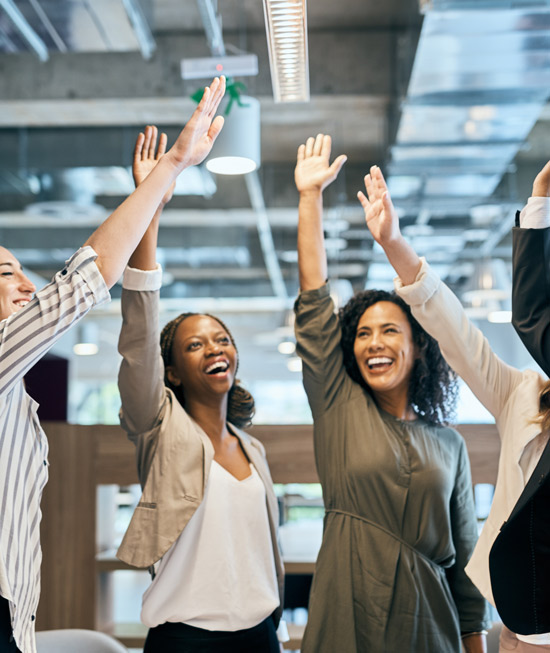 four diverse women celebrating with raised hands in a modern office environment joyful teamwork achievement 1 success collaboration